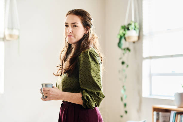 istock Young woman taking coffee break in home office 2192956244
