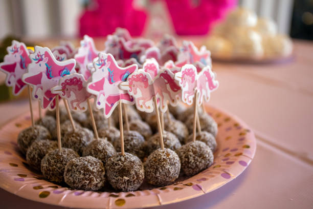 Raw candy with coconut sprinkles on sticks for children's birthday