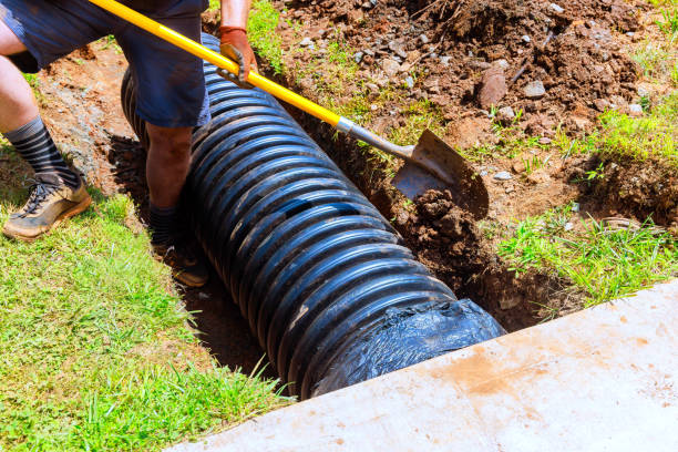 istock Construction of a trench for drainage black pipe at construction site 2192960277