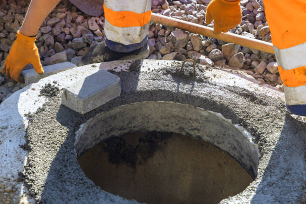 istock Fresh concrete is being poured to bind blocks forming top section of a underground utility manhole 2192960469