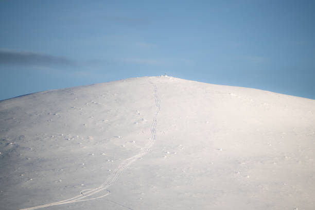 istock snow covered mountain peak in a sunny day with a clear blue sky. 2192960485