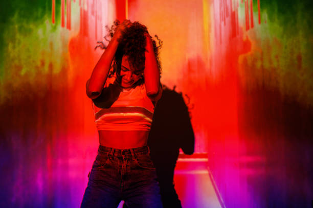 Young woman in a vibrant colored setting, expressing emotion, joy, and authenticity.