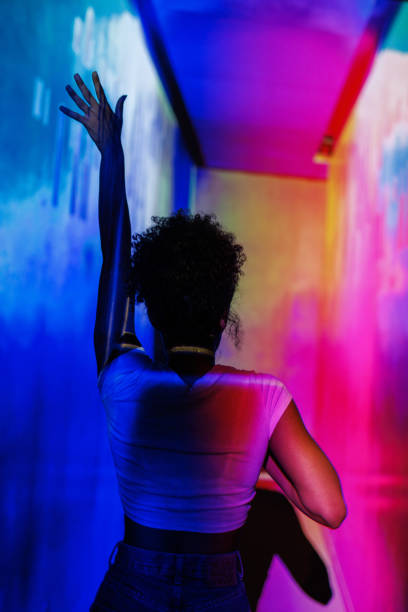 istock Individual enjoying colorful lights in an artistic and immersive environment 2192965313