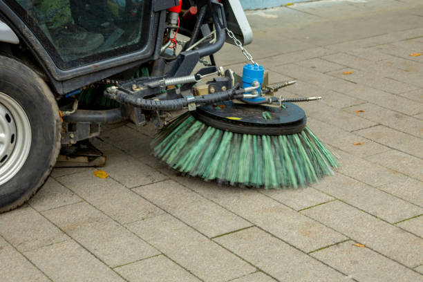 istock Street cleaning machine operates on paved walkway to maintain cleanliness and remove debris during afternoon hours in an urban area 2192965351