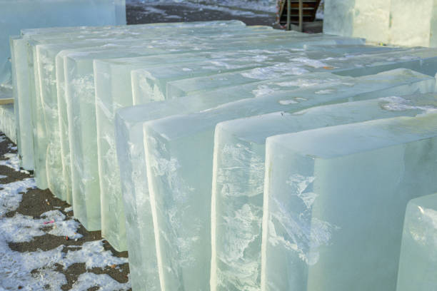 istock Large blocks of clear ice stacked on a snowy surface in a cold environment during daylight hours 2192965387
