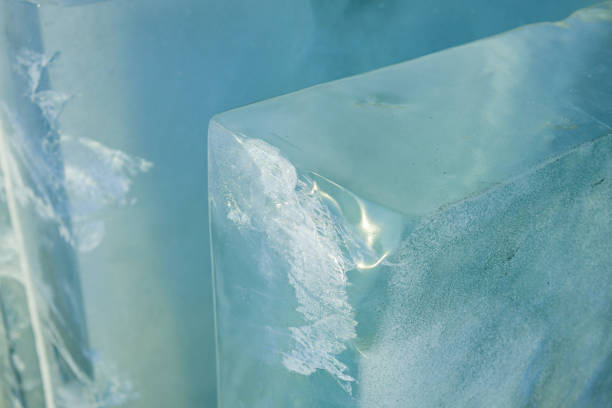 istock Clear ice blocks glistening under light, showcasing natural texture in a bright setting with water reflections 2192965398