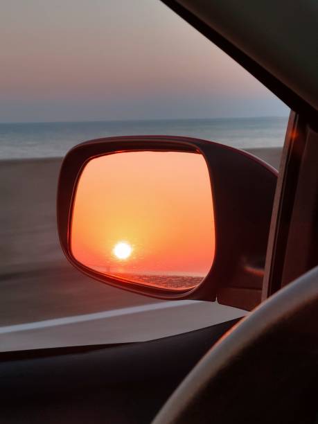 istock Fire sunset reflected in the rearview mirror of the vehicle 2192966021