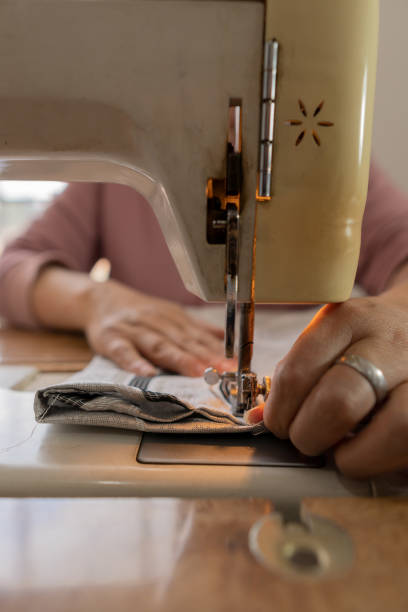 istock woman at home sewing curtain with a sewing machine 2192971281