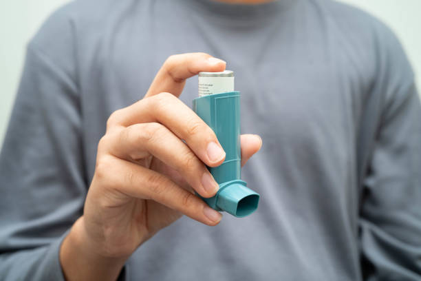 istock Asthma and chronic obstructive pulmonary disease COPD, Asian young man using metered dose inhaler MDI. 2192971717