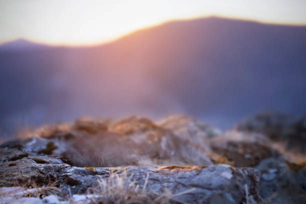 A serene sunset casts soft light on a stunning rocky terrain, perfect for nature lovers seeking peace and beauty