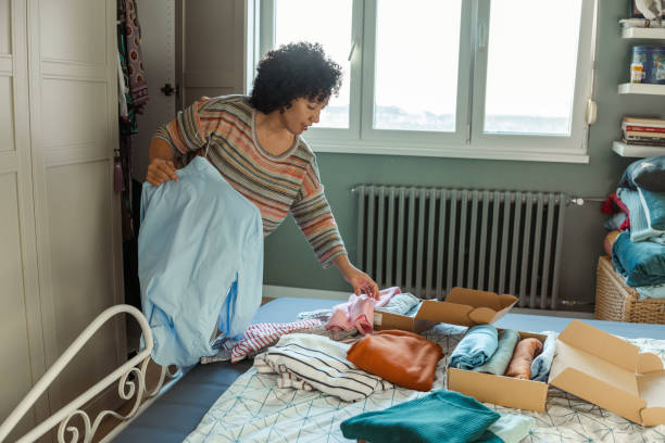 istock Smiling woman sorting clothes at home 2192973214