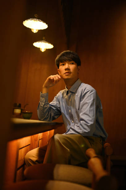 istock A Smart Asian man sitting at the counter bar table looking sideways 2192973523
