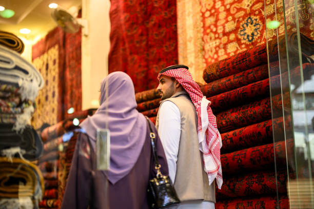 istock Back view young generation Z Middle Eastern couple walking into traditional carpet shop 2192976477