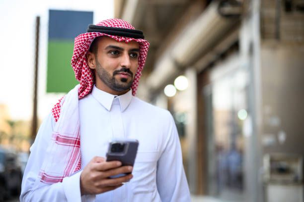 istock Young man using smart phone to find his way walking on city streets 2192977997