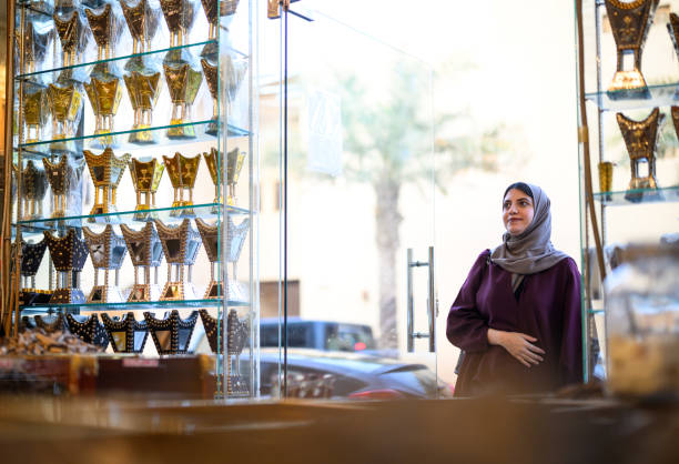 istock Wide shot young Middle Eastern woman entering perfume store in souk 2192978018