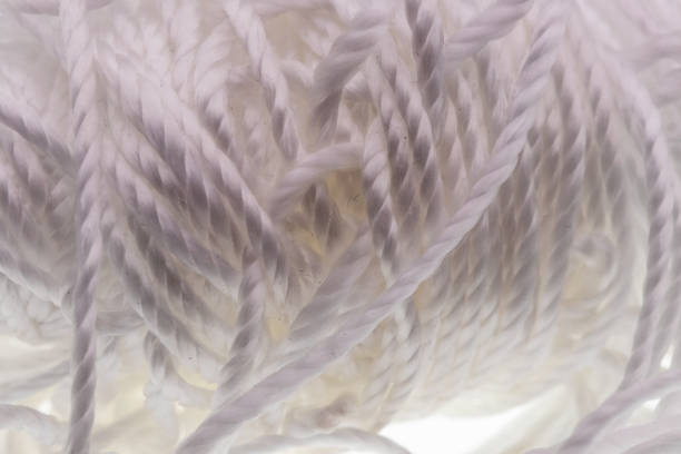 Spool of white cotton string up close tangles. High quality photo