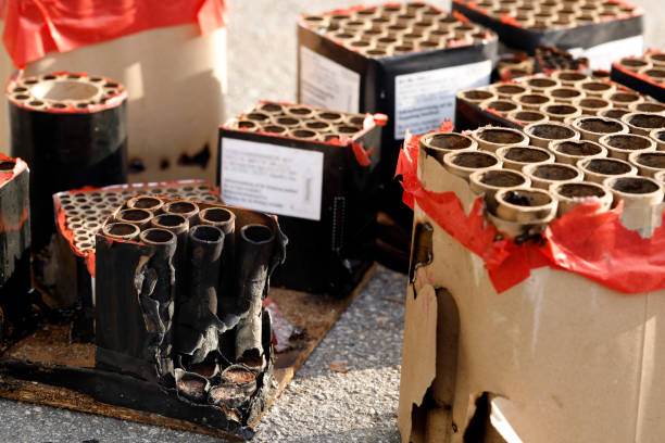istock Batteries with fired fireworks on street in sunlight, trash from spent fireworks on New Year's Day, environmental impact from disposal costs and cleanup 2192979785