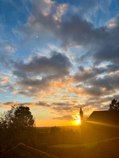 istock Sunset through Clouds Grey Overcast Weather Climate Trees Surrey Reigate Nature England United Kingdom UK Tree House Pretty Calm Beauty 2192980302