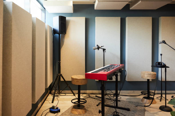istock Interior view of a sound studio with a piano synthesizer, a microphone, and speakers. 2192981686