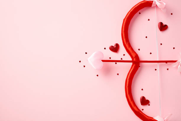 istock Valentines Day flat lay composition with cupid bow and arrow on light pink background. Love, romance concept. St Valentine's Day greeting card design. 2192982188
