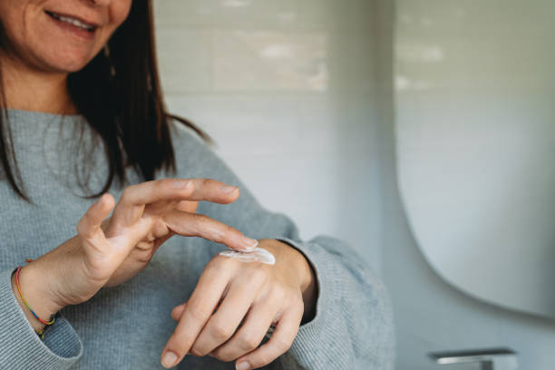 istock Woman applying moisturizing cream on her hand 2192982936