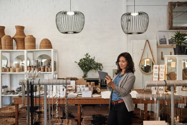 istock Young Asian woman using a digital tablet in her boutique 2192985936