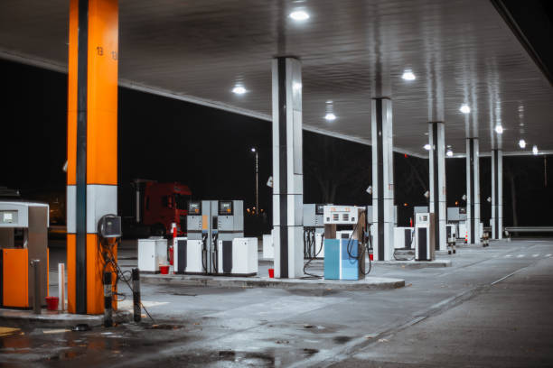 istock Lit gas station at night with pumps 2192986214