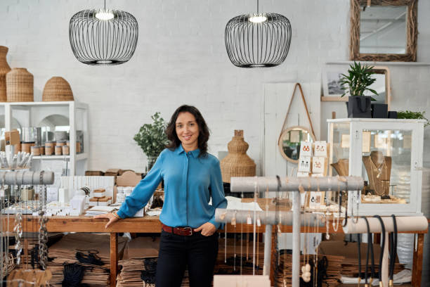 istock Smiling Asian entrepreneur standing by a counter in her store 2192986298