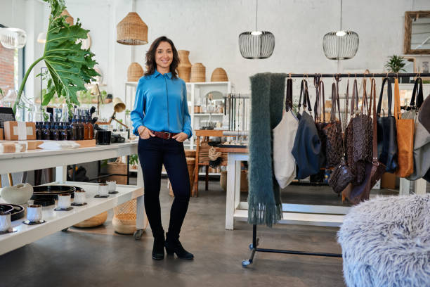 istock Smiling young Asian entrepreneur standing in her trendy store 2192986816