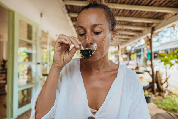 Woman Enjoying a Drink in Rustic Outdoor Setting
