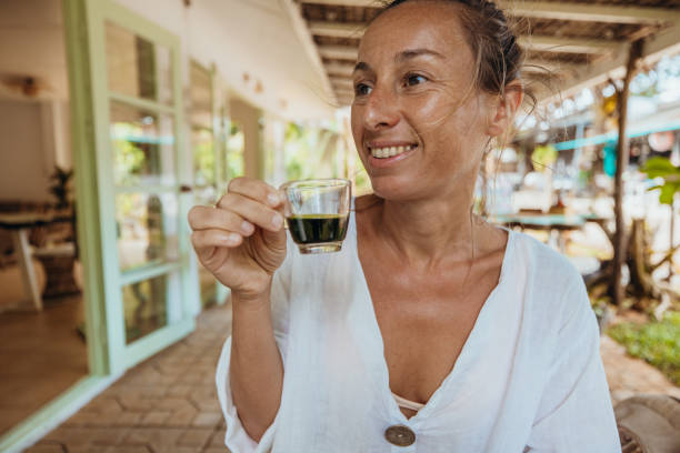 Woman Enjoying a Drink in Rustic Outdoor Setting