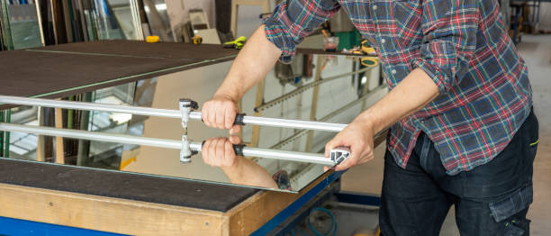 istock glazier cutting glass with a hand tool, close up 2192988767