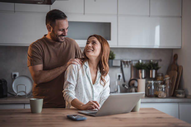 istock Happy couple having fun while drinking coffee in the kitchen. 2192989904