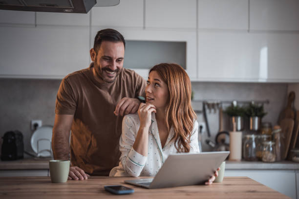 istock Happy couple having fun while drinking coffee in the kitchen. 2192989938
