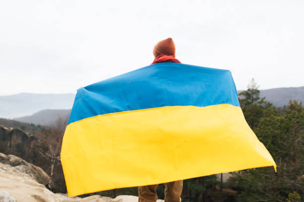 istock Unrecognisable man with a Ukrainian flag in nature 2192990324