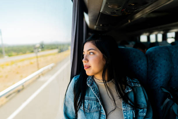 istock Young tourist woman looking through the window inside the bus 2192992009