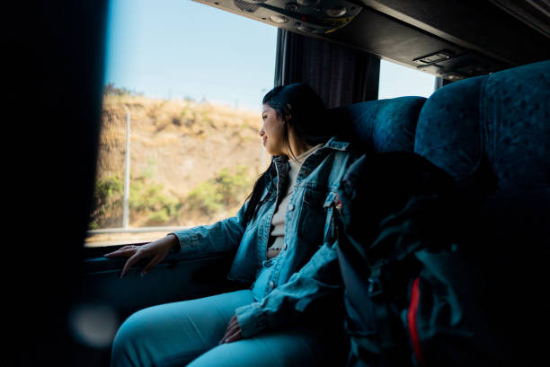 istock Young tourist woman looking through the window inside the bus 2192992010