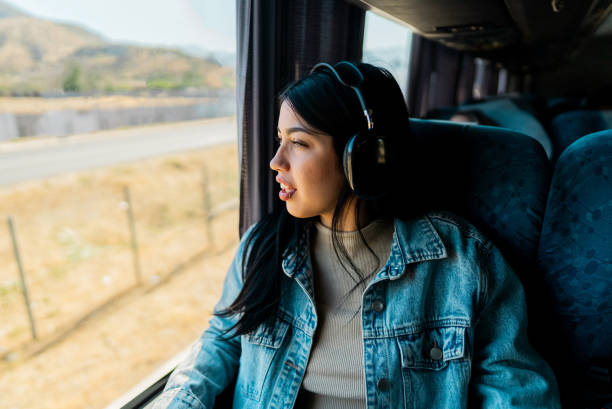 istock Young tourist woman looking through the window inside the bus 2192992014