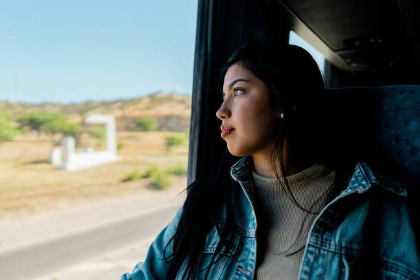 istock Young tourist woman looking through the window inside the bus 2192992304