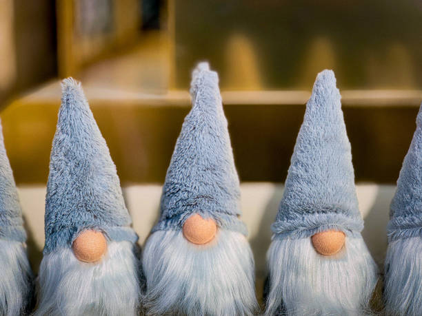 Three charming holiday gnomes with long blue hats and white beards, perfect for festive table decorations.