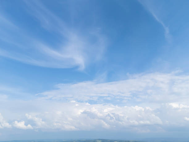A beautiful view of blue sky with white clouds, creating a serene atmosphere in nature.