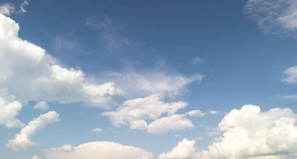 istock Cloudy sky with white clouds scattered across a bright blue background, creating a serene and peaceful atmosphere. Ideal for nature-themed projects. 2192995338