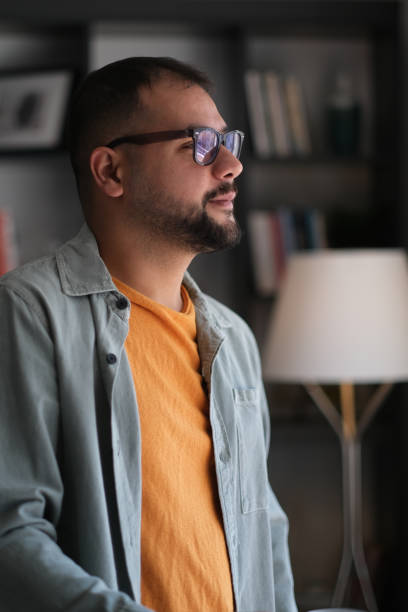 istock Carefree man day dreaming by the window. 2192996987