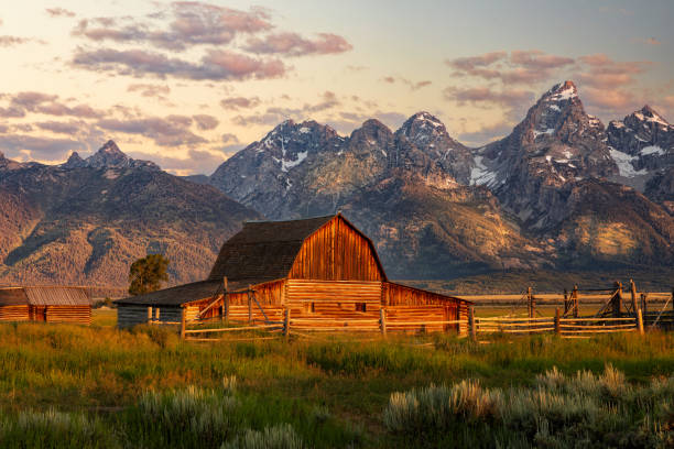 istock Sunrise Over Barn and Teton Mountains Landscape 2192998780