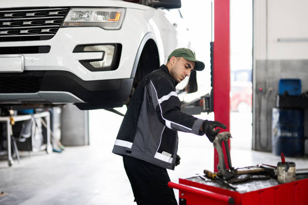 istock Auto mechanic working on car repair in a professional garage 2193000351