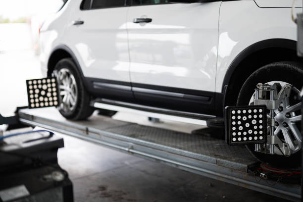 istock Car on lift for wheel alignment service in auto shop 2193000598