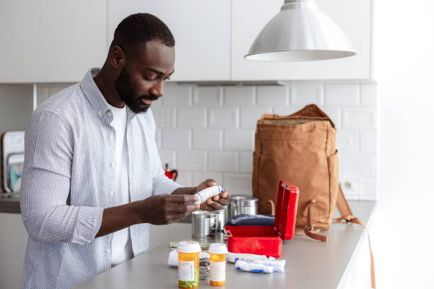 istock Home emergency kit preparation: man packing emergency supplies at home 2193000789