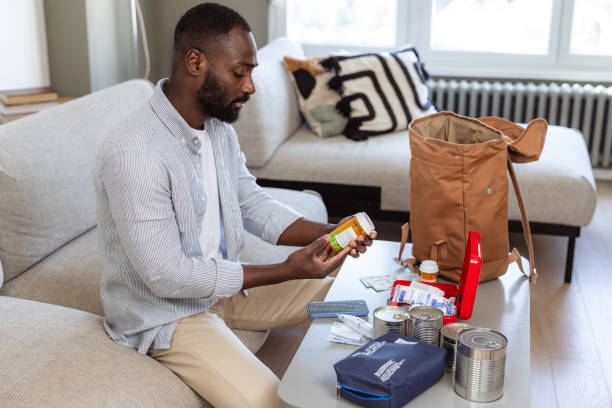 istock Man reviewing survival items for preparing emergency kit at home 2193000816
