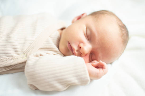 istock newborn baby, 23 days old, sleeping. 2193000940