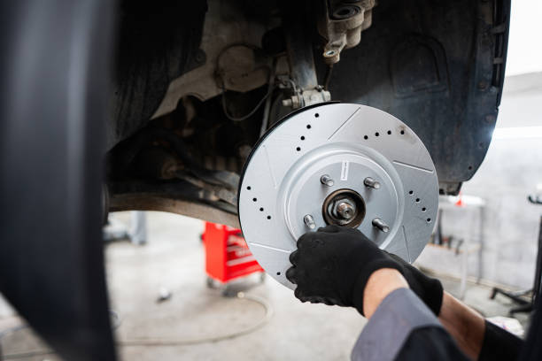 istock Mechanic installing new brake disc on a vehicle 2193001138
